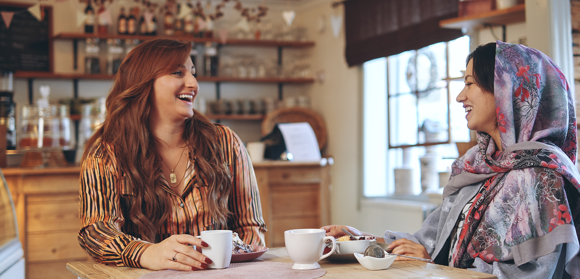 Kvinnor som skrattar på ett café.
