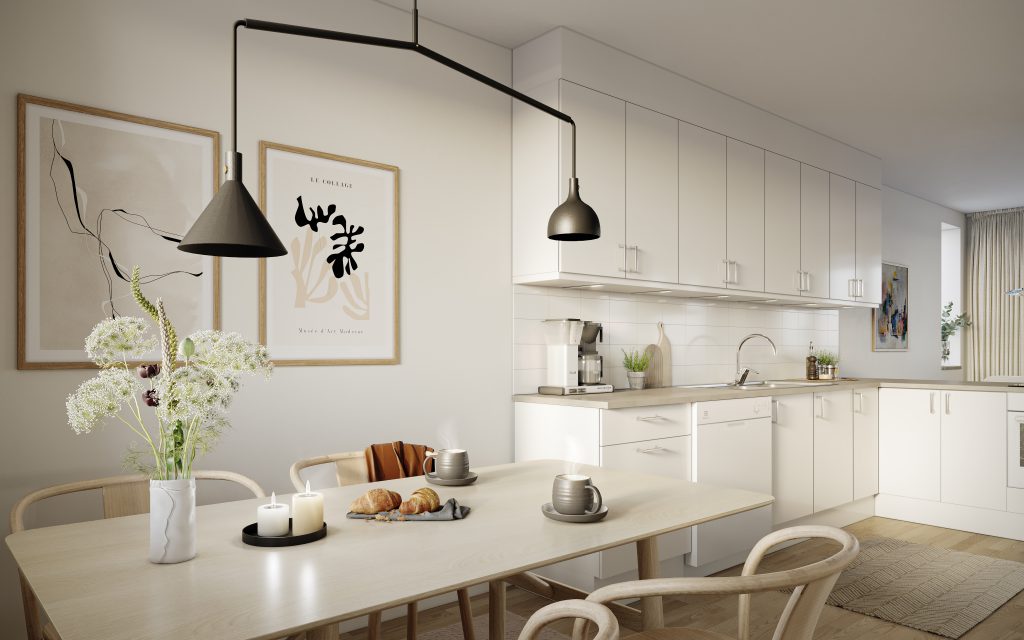 Bilden visar hur ett kök ser ut i radhusen. Vita luckor, trägolv och ljusa väggar.