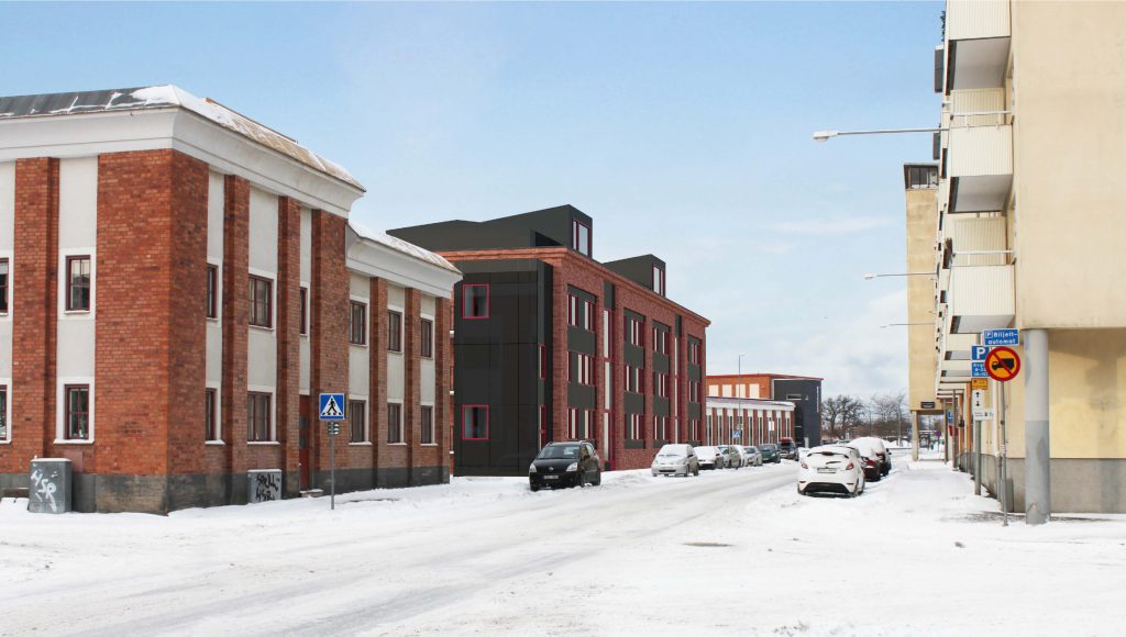 en snölagd gata mellan lägenhetshus